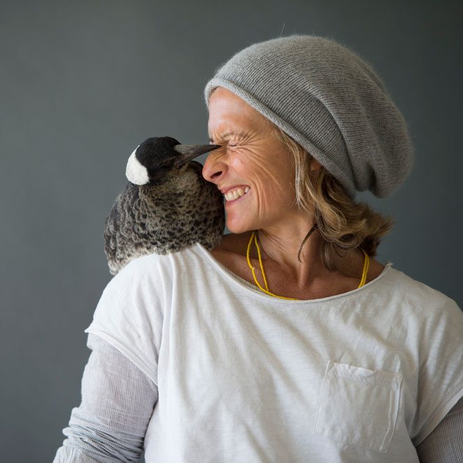 Photo of Melbourne Disability Expo ambassador Sam Bloom smiling with a penguin sitting on her shoulder