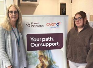 Parent Pathways Participant with her mentor at the CVGT Employment Melton office standing next to a sign.