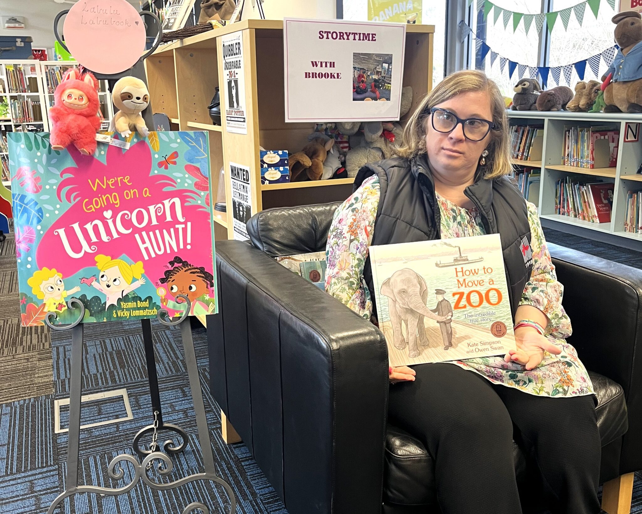 Brooke who has Down Syndrome holds a book in the local school library