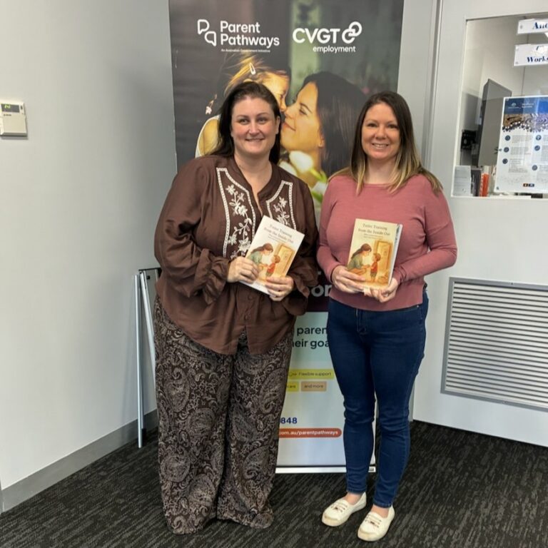 Mother and mentor in office holding new published book.