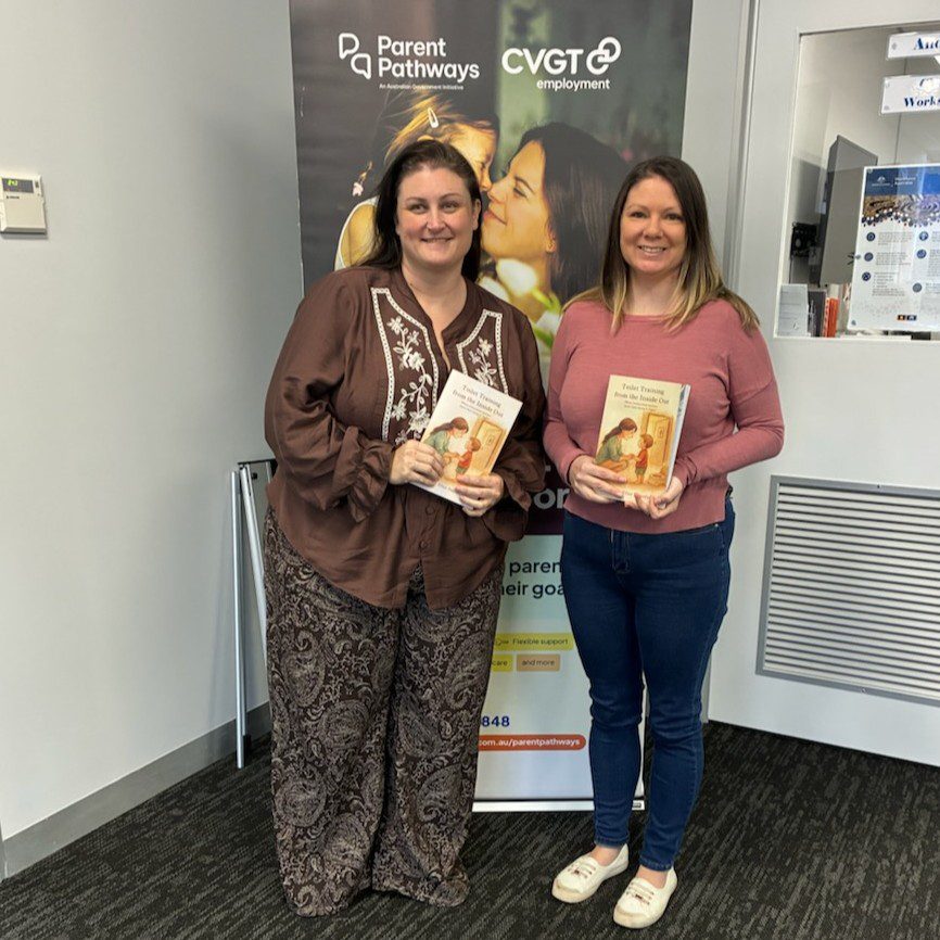 Mother and mentor in office holding new published book.